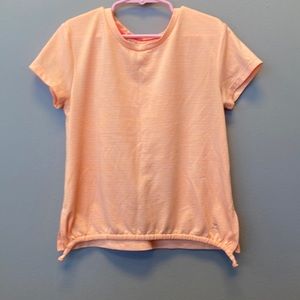 Cute short sleeved peach colored girls athletic shirt with draw string.